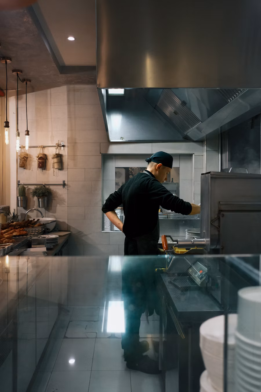 Chef cooking in a busy restaurant kitchen