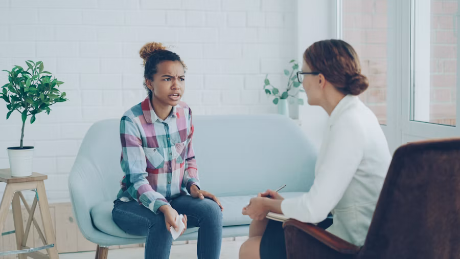 Therapist talking with a client in a counseling office